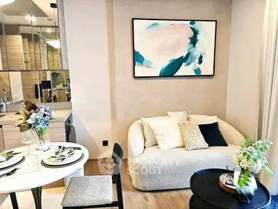 Stylish modern living room with cozy sofa, elegant dining area, and chic decor in a contemporary apartment.