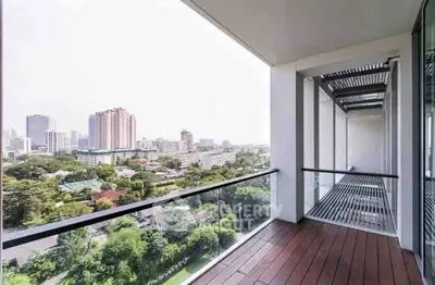 Spacious balcony with stunning cityscape view, perfect for relaxation and enjoying urban living.
