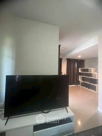 Modern living room with sleek TV and stylish shelving unit