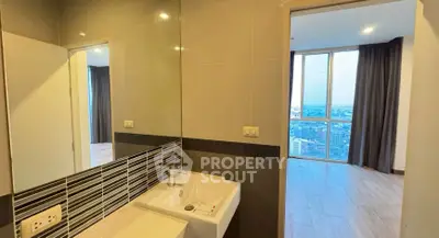 Modern bathroom with city view from adjacent room