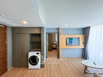 Modern living room with built-in laundry area and stylish decor