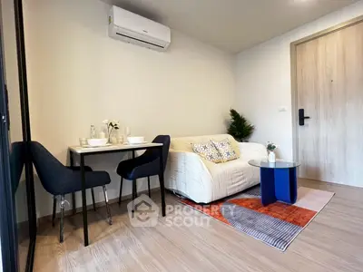 Modern living room with cozy sofa, dining area, and stylish decor