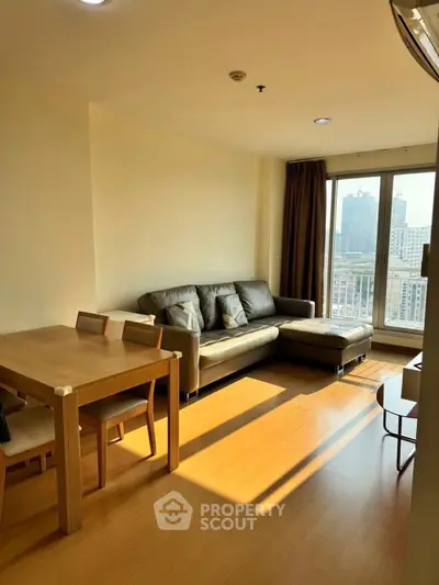 Bright living room with modern furniture and city view, perfect for urban living.