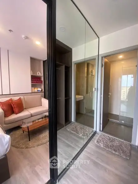 Modern apartment interior with cozy living room and adjacent bathroom, featuring sleek design and stylish decor.