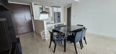 Modern open-layout kitchen with dining area and sleek furniture