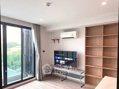 Modern living room with large window and built-in shelves