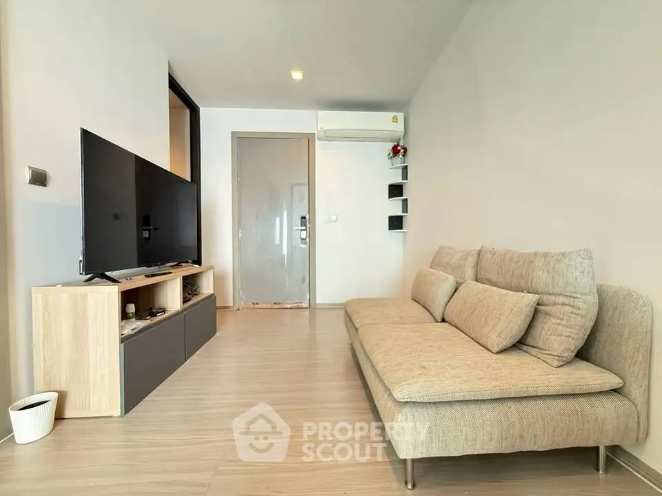 Modern living room with sleek furniture and flat-screen TV, perfect for cozy relaxation.
