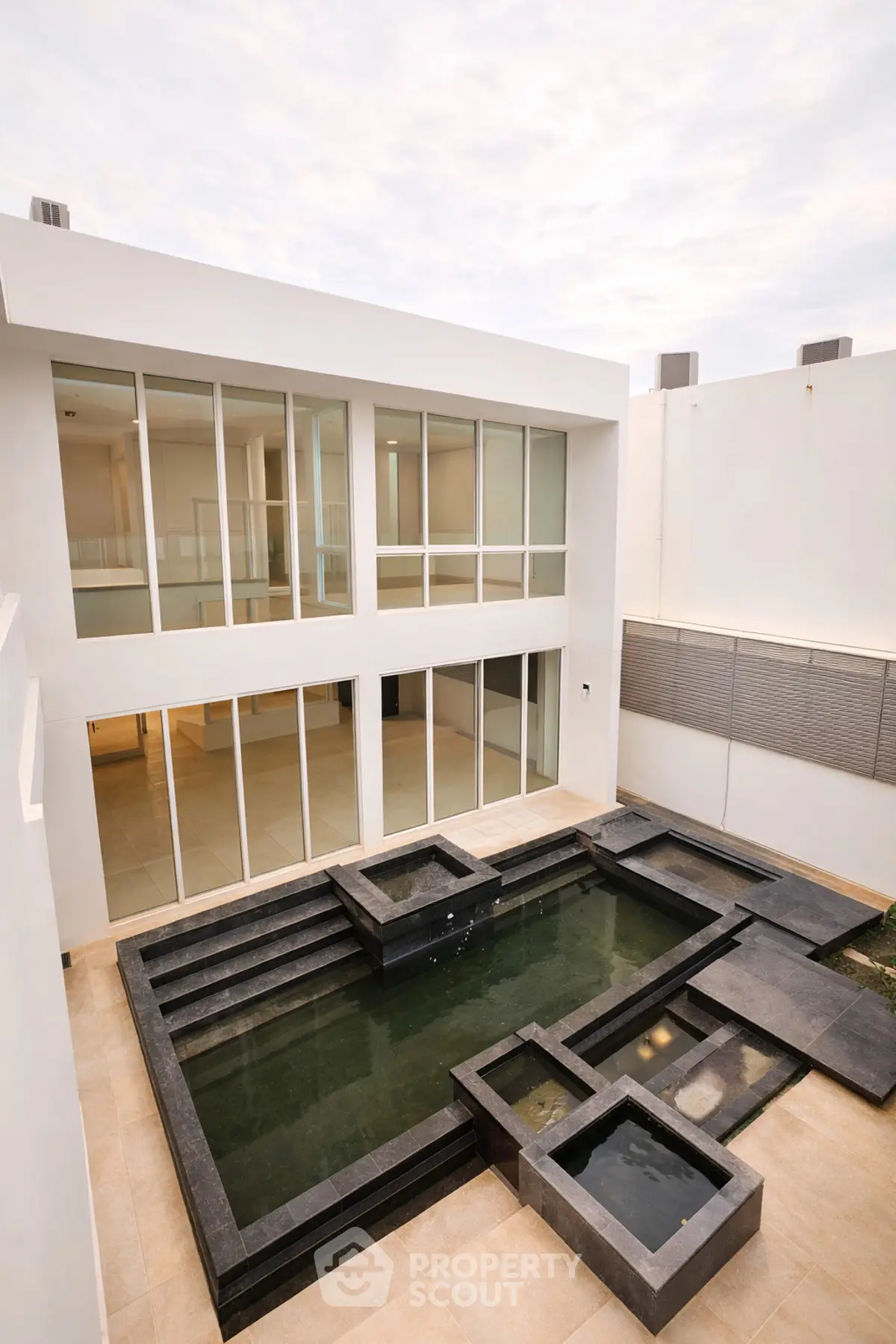 Modern architectural exterior with sleek water feature and large glass windows