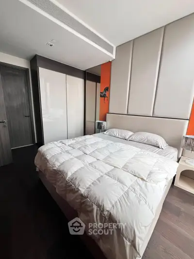 Modern bedroom with stylish decor and ample storage in a contemporary apartment.