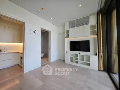 Modern living room with built-in TV unit and open kitchen layout
