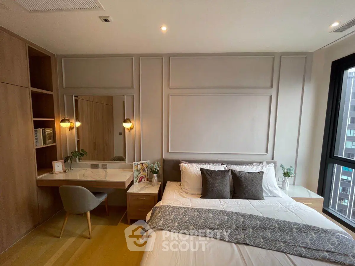 Modern bedroom with stylish decor and natural light, featuring a cozy bed and elegant workspace.