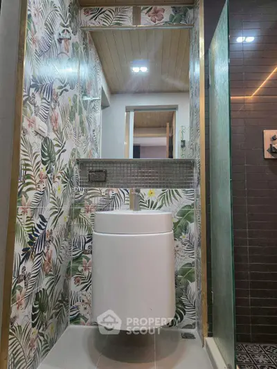 Stylish bathroom with floral wallpaper and modern fixtures