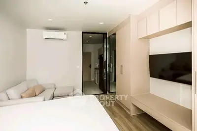 Modern bedroom with sleek design, featuring a wall-mounted TV and air conditioning for ultimate comfort.