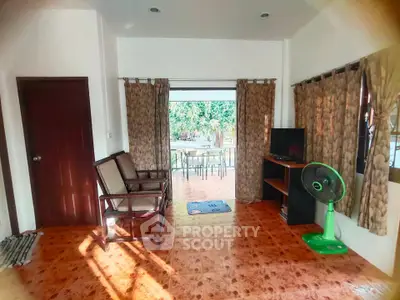Charming living room with open layout and garden view, featuring cozy seating and natural light.