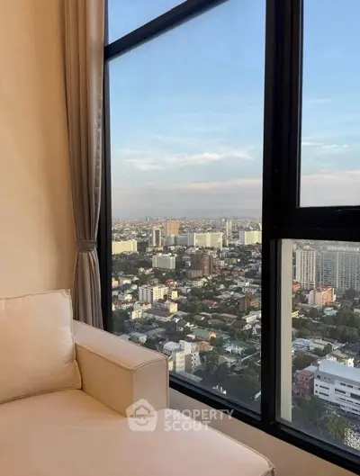 Stunning high-rise apartment view with expansive cityscape from a cozy living room.