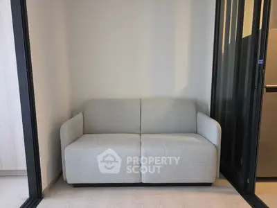 Modern compact living room with sleek gray sofa and sliding glass doors