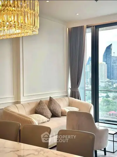 Luxurious living room with elegant sofa and stunning city view through large windows.