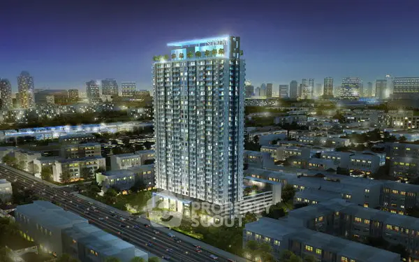 Stunning night view of a modern high-rise building in a vibrant cityscape.