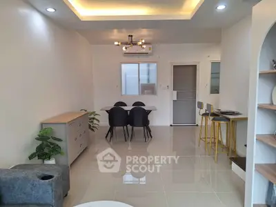 Modern living room with sleek dining area and stylish lighting