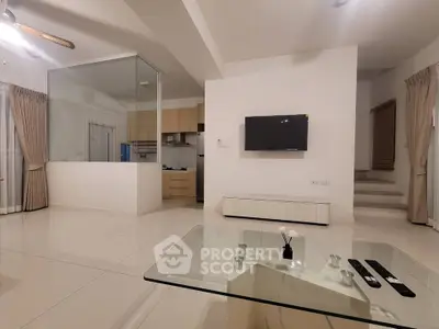 Spacious modern living room with open kitchen and sleek glass coffee table