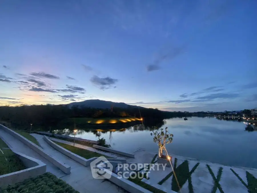 Stunning lakeside view at dusk with serene landscape and modern pathways.