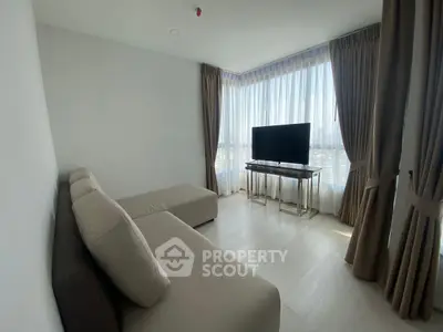 Modern living room with large windows and stylish furniture, offering a bright and airy atmosphere.