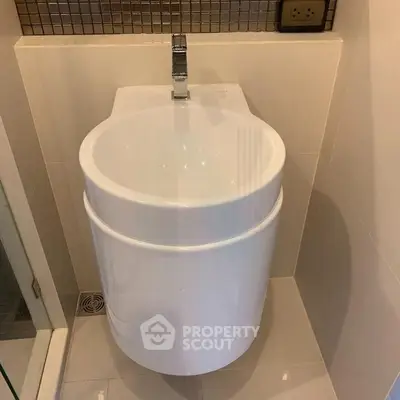 Modern bathroom with unique round sink and sleek faucet design