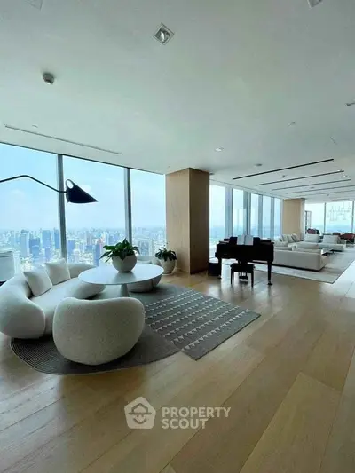 Luxurious modern living room with panoramic city views and elegant furnishings.