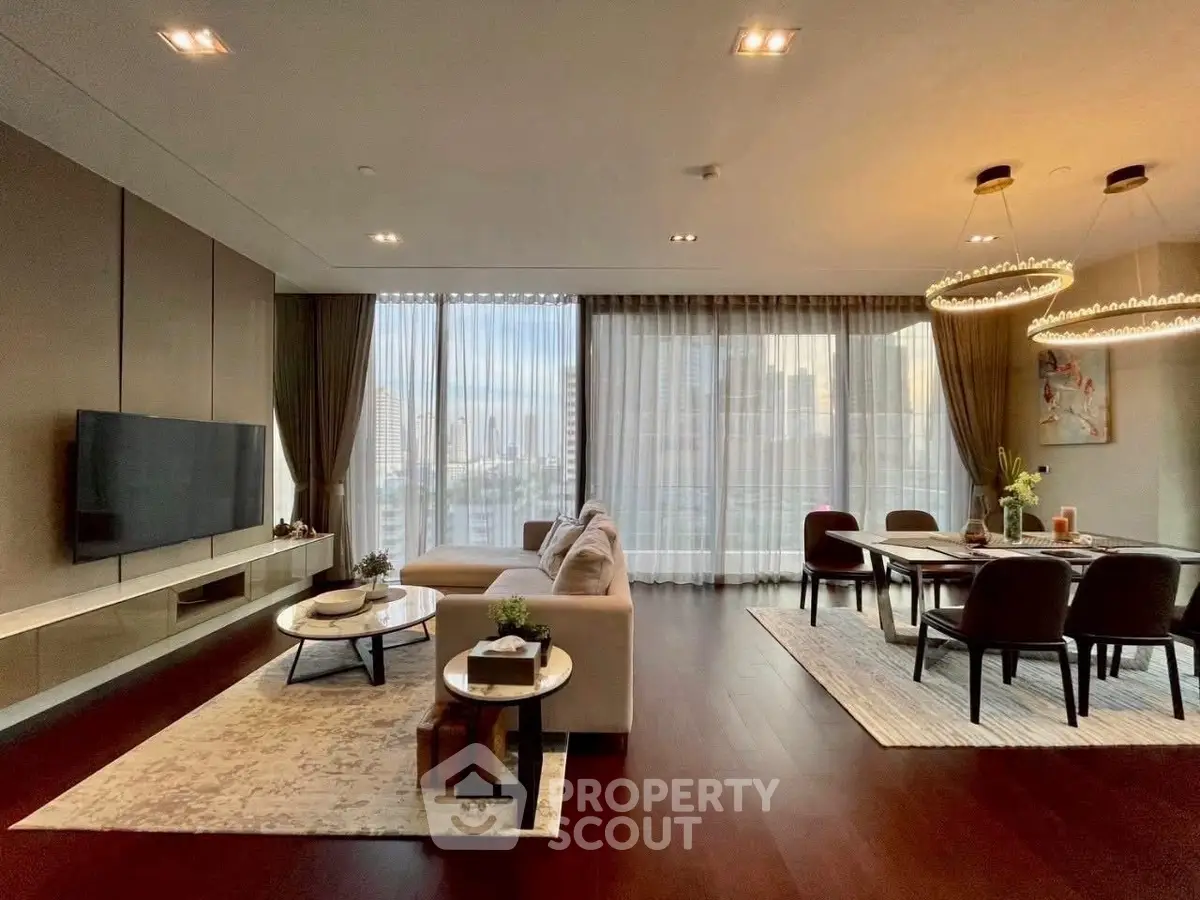 Luxurious open-plan living and dining area with city views, elegant decor, and modern lighting.