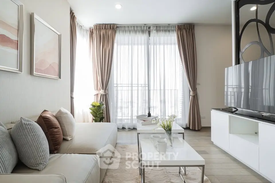 Modern living room with elegant decor, large windows, and stylish furniture in a bright apartment.