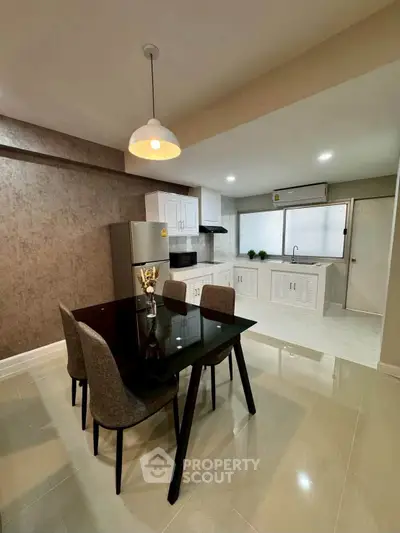Modern dining area with sleek kitchen featuring open layout and stylish decor