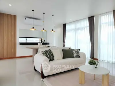 Modern living room with stylish sofa and pendant lights