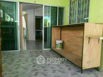 Spacious balcony with sliding glass doors and tiled flooring, perfect for relaxation.