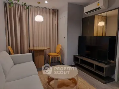 Modern living room with stylish furniture and large TV, perfect for relaxation and entertainment.