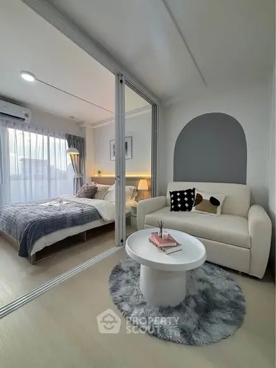 Modern bedroom with cozy seating area and stylish decor