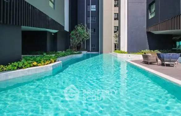 Luxurious apartment complex with a stunning outdoor pool and modern design.