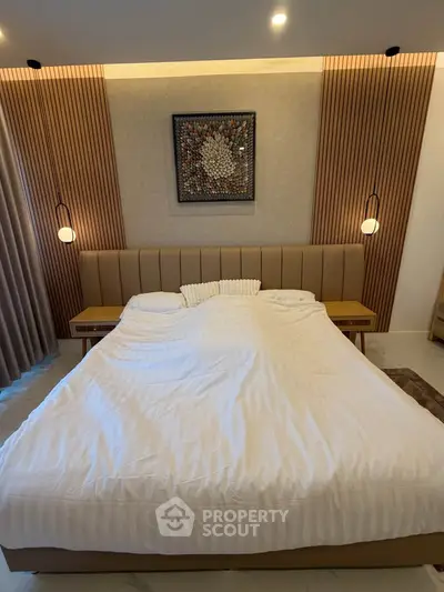 Luxurious bedroom with modern design and elegant lighting, featuring a comfortable bed and stylish decor.