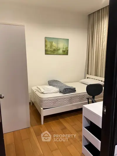 Cozy bedroom with modern decor and wooden flooring