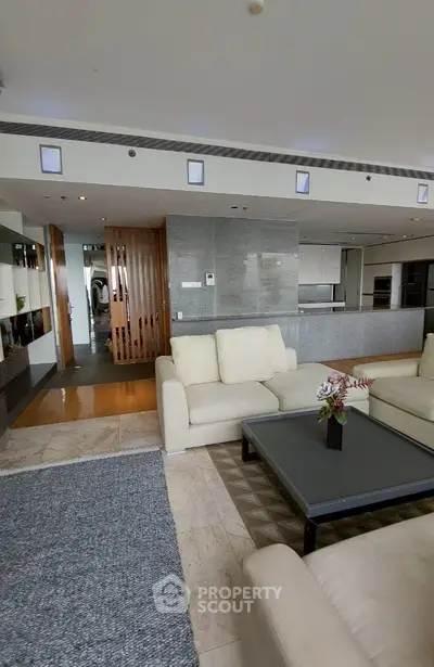 Spacious modern living room with open kitchen and elegant decor