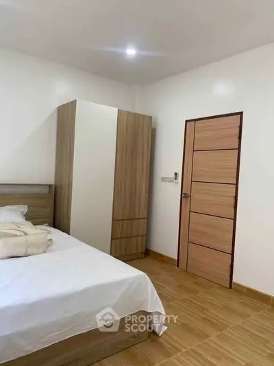 Cozy bedroom with wooden wardrobe and modern design