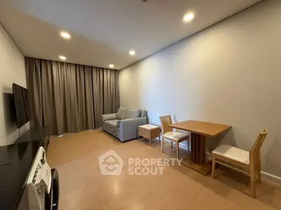 Spacious living room with modern furniture and natural lighting, perfect for relaxation and entertainment.