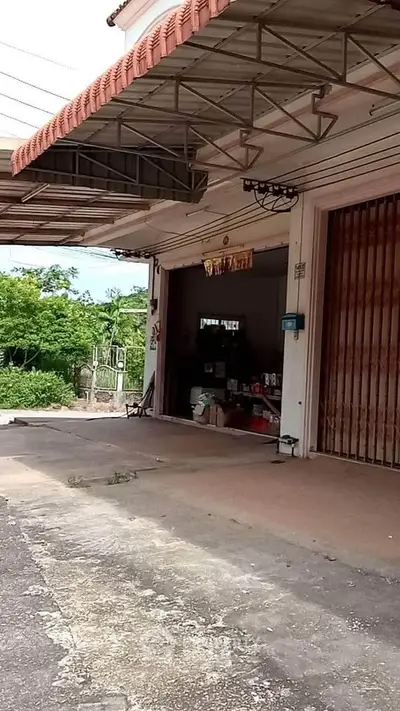 Spacious garage with open entrance and outdoor view, ideal for storage or workshop space.