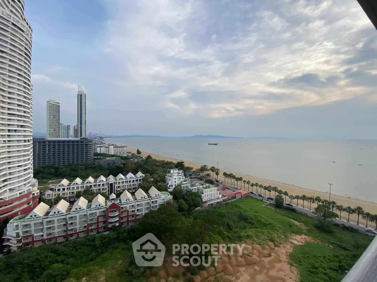 Stunning beachfront view with modern high-rise buildings and lush greenery.