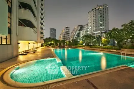 Luxurious residential complex with a stunning outdoor pool and modern architecture.