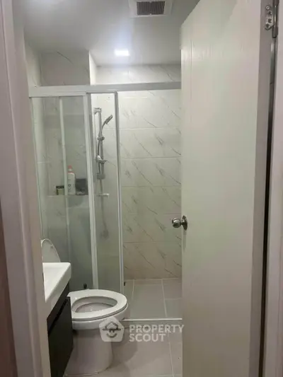 Modern bathroom with glass shower enclosure and sleek fixtures