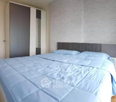 Modern bedroom with stylish brick accent wall and cozy bedding