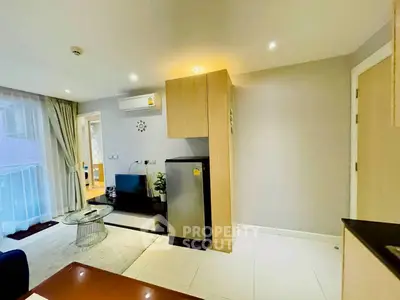 Modern living room with sleek design and compact kitchen area