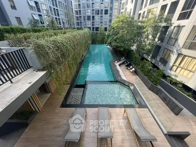 Luxurious apartment complex with stunning pool and lush greenery