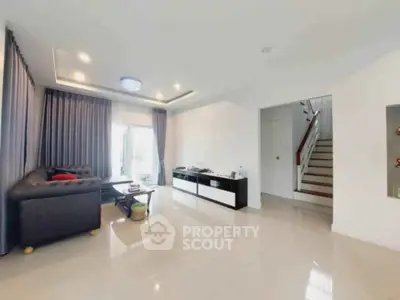 Spacious modern living room with sleek design and ample natural light