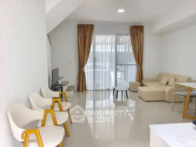 Spacious modern living room with elegant furniture and large windows for natural light.